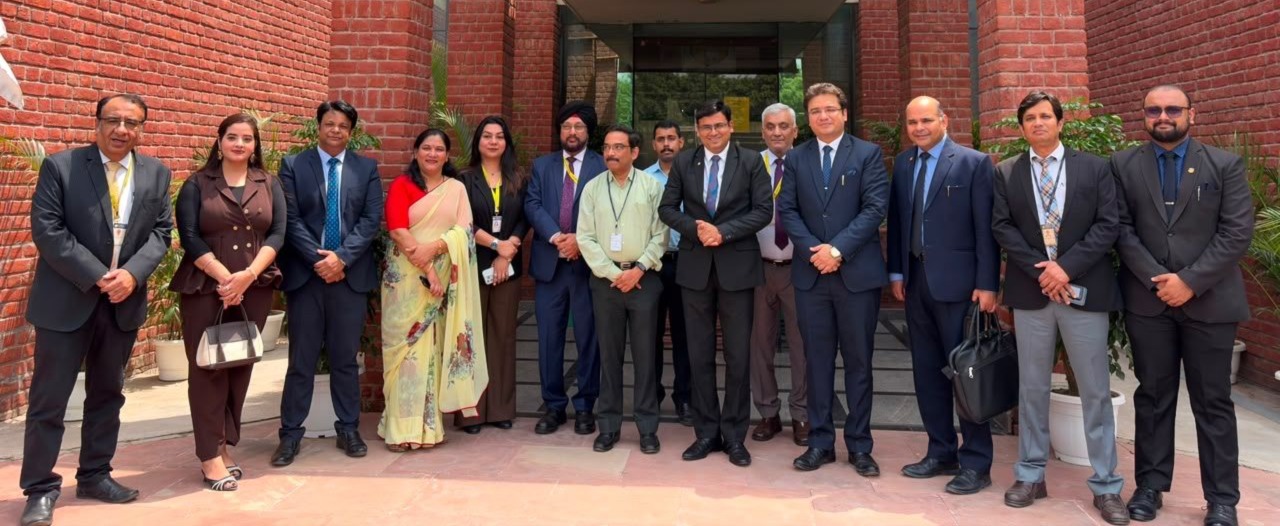 Dr Ajay Rana with university staff in a group photo